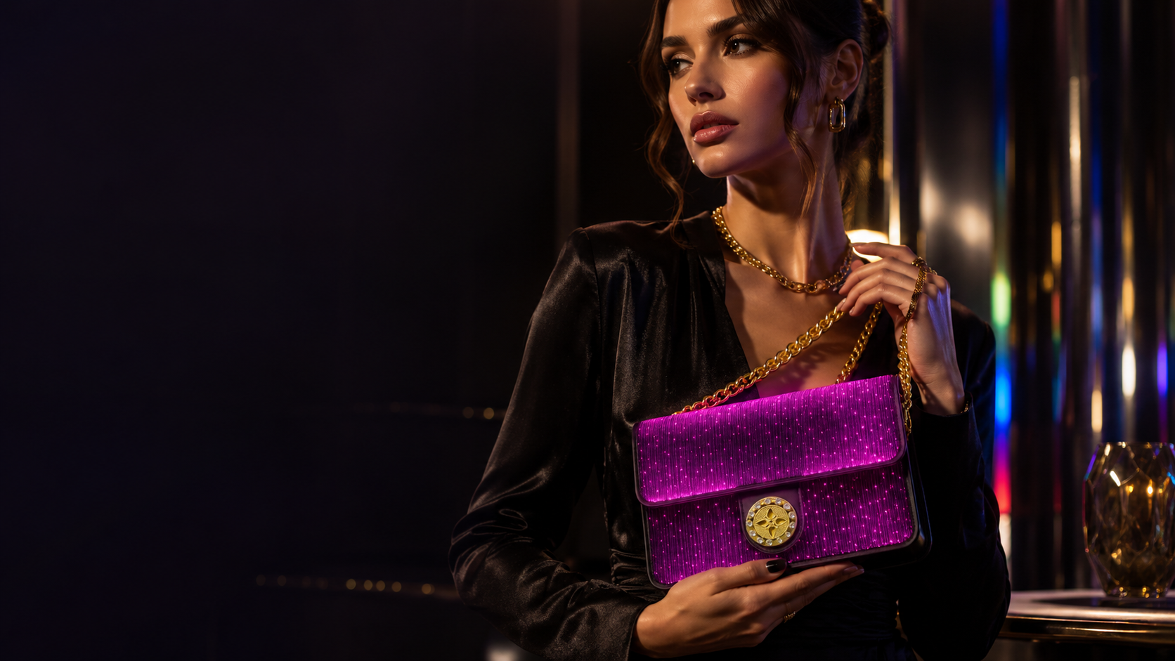 Woman in an elegant evening setting holding the glowing Haske Aura Bag